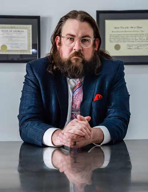 A picture of me sitting at a conference table.